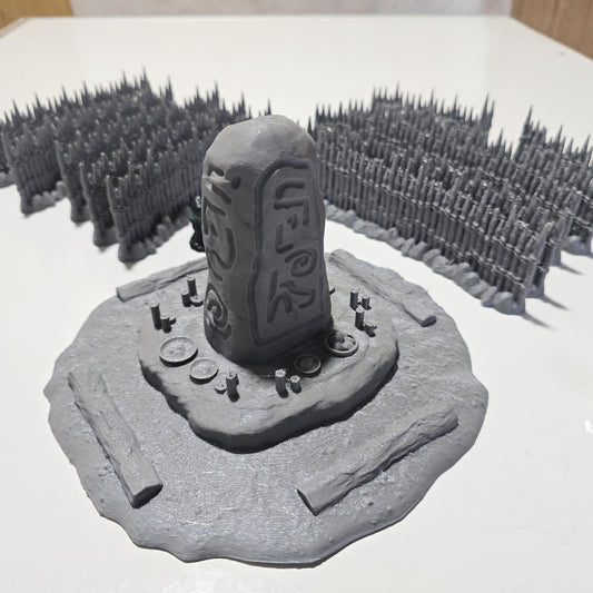 Unpainted gray PLA captures the rough ground, carved runestone, and jagged timber spikes of this 28 mm tabletop terrain set. The monolith rises from a layered base scattered with simple offerings, while the spiked walls form a full circle around the site. Each piece shows the subtle lines of 3D printed construction, ready for primer. Designed for DnD / Pathfinder / wargaming on a 1-inch grid, it stands as a stark landmark on any table.