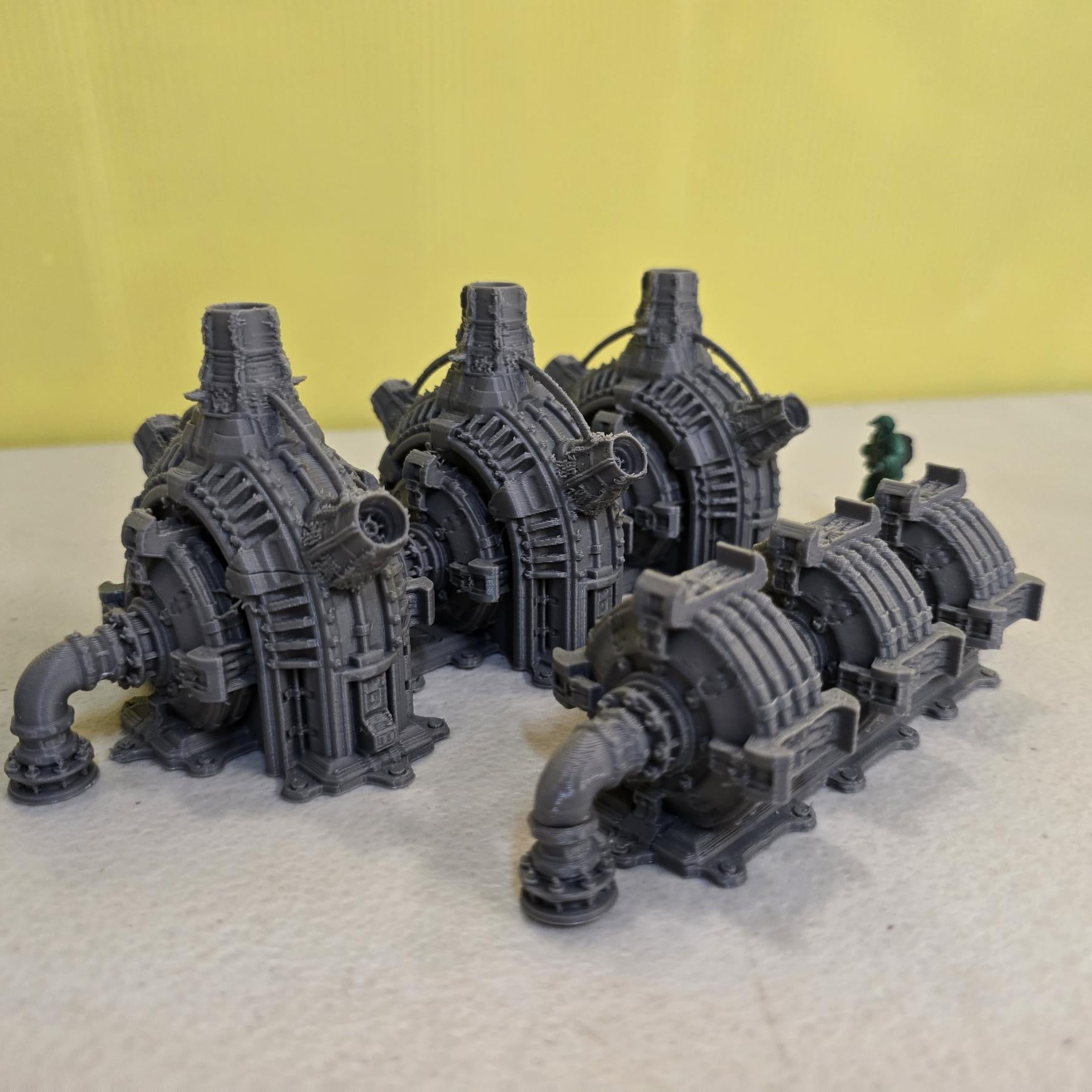Grimdark power generator cells with ribbed housings, arched industrial frames, vent stacks, and curved pipe connections. Scaled for DnD / Pathfinder / wargaming. Miniatures and a D20 to show their footprint on a 1-inch grid. Several variants appear as single units and linked multi-cell arrays, giving the set the look of a dense industrial power system. Built as sci-fi scatter terrain, these generator cells bring heavy mechanical detail and battlefield atmosphere to any tabletop terrain layout.
