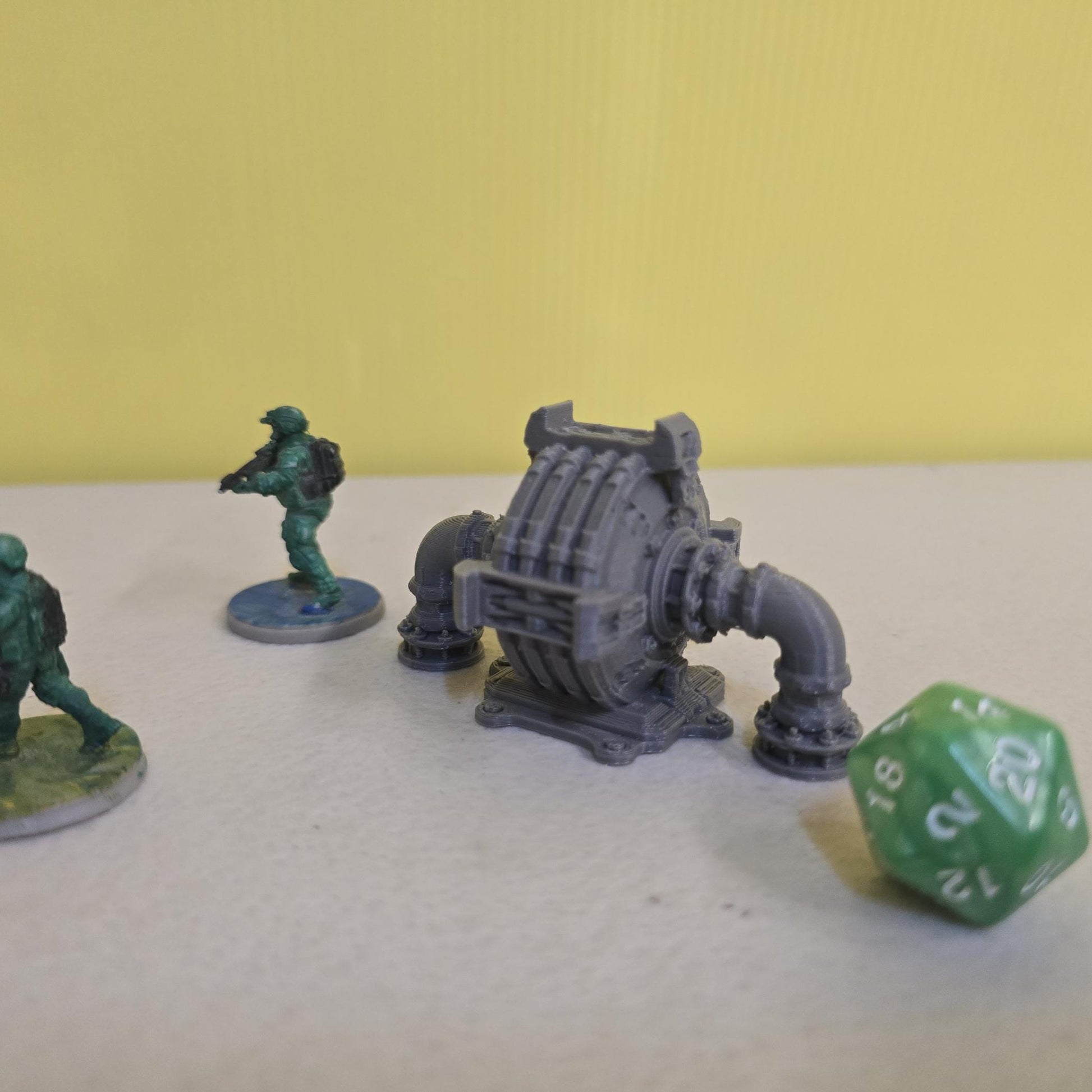 Grimdark power generator cells with ribbed housings, arched industrial frames, vent stacks, and curved pipe connections. Scaled for DnD / Pathfinder / wargaming. Miniatures and a D20 to show their footprint on a 1-inch grid. Several variants appear as single units and linked multi-cell arrays, giving the set the look of a dense industrial power system. Built as sci-fi scatter terrain, these generator cells bring heavy mechanical detail and battlefield atmosphere to any tabletop terrain layout.