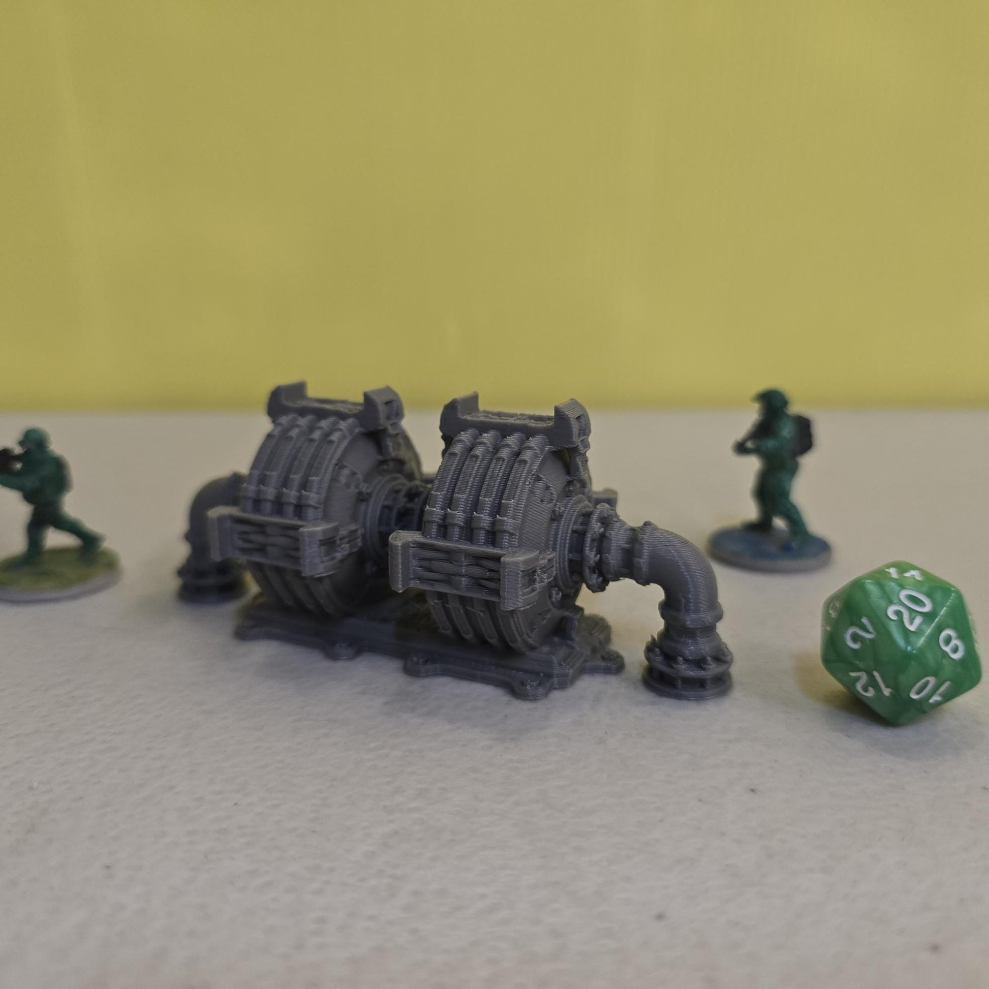 Grimdark power generator cells with ribbed housings, arched industrial frames, vent stacks, and curved pipe connections. Scaled for DnD / Pathfinder / wargaming. Miniatures and a D20 to show their footprint on a 1-inch grid. Several variants appear as single units and linked multi-cell arrays, giving the set the look of a dense industrial power system. Built as sci-fi scatter terrain, these generator cells bring heavy mechanical detail and battlefield atmosphere to any tabletop terrain layout.
